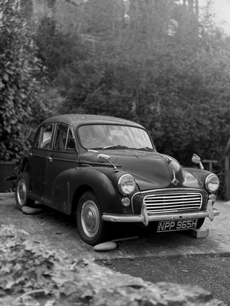 Classic Morris Minor parked, captured in monochrome, Wales.